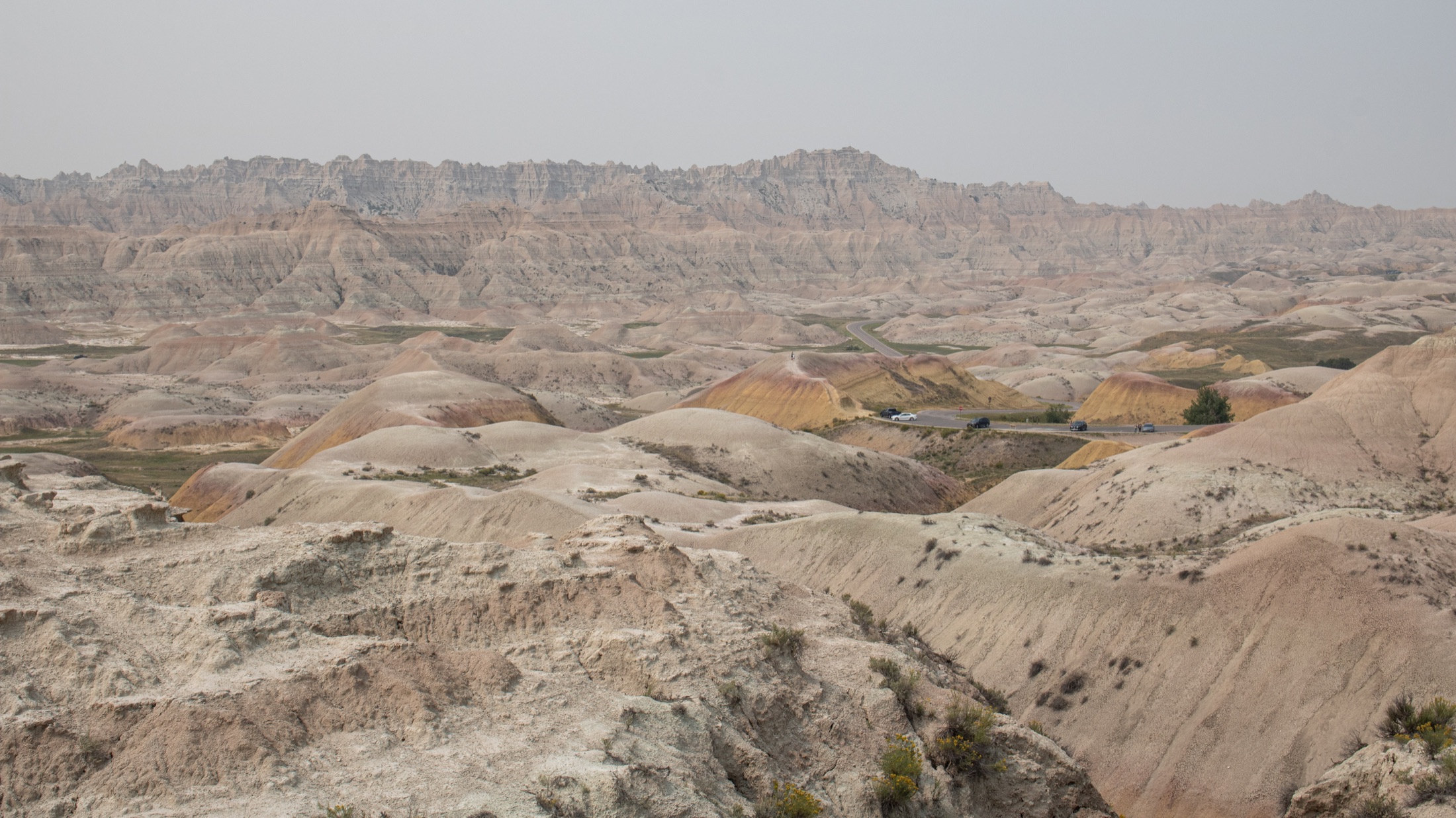 Layered formations and a winding road in Badlands National Park